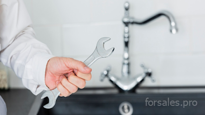 Professional emergency plumbing Manchester technician fixing a pipe leak